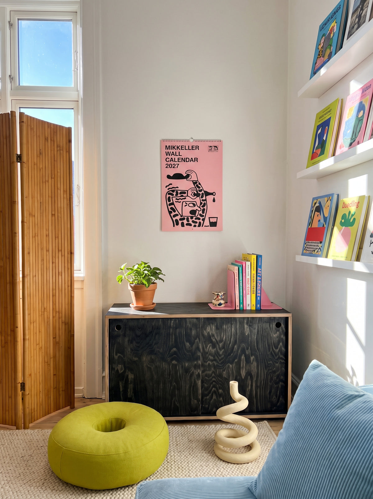 Mikkeller Wall Calendar 2027 cover hanging in a sunny living room
